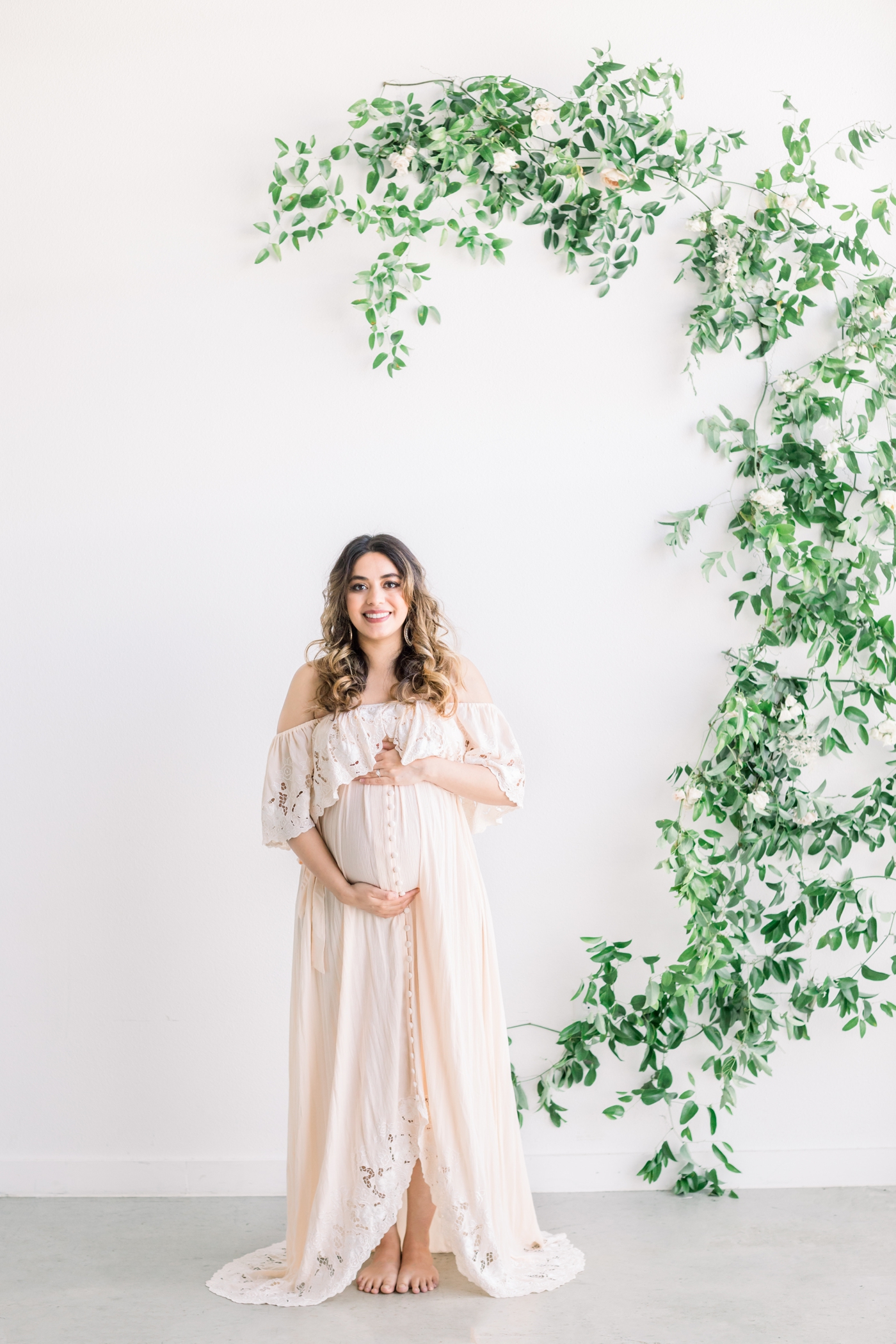 Maternity portrait of mom wearing maxi dress in North Austin, TX studio. Photo by Sana Ahmed Photography.