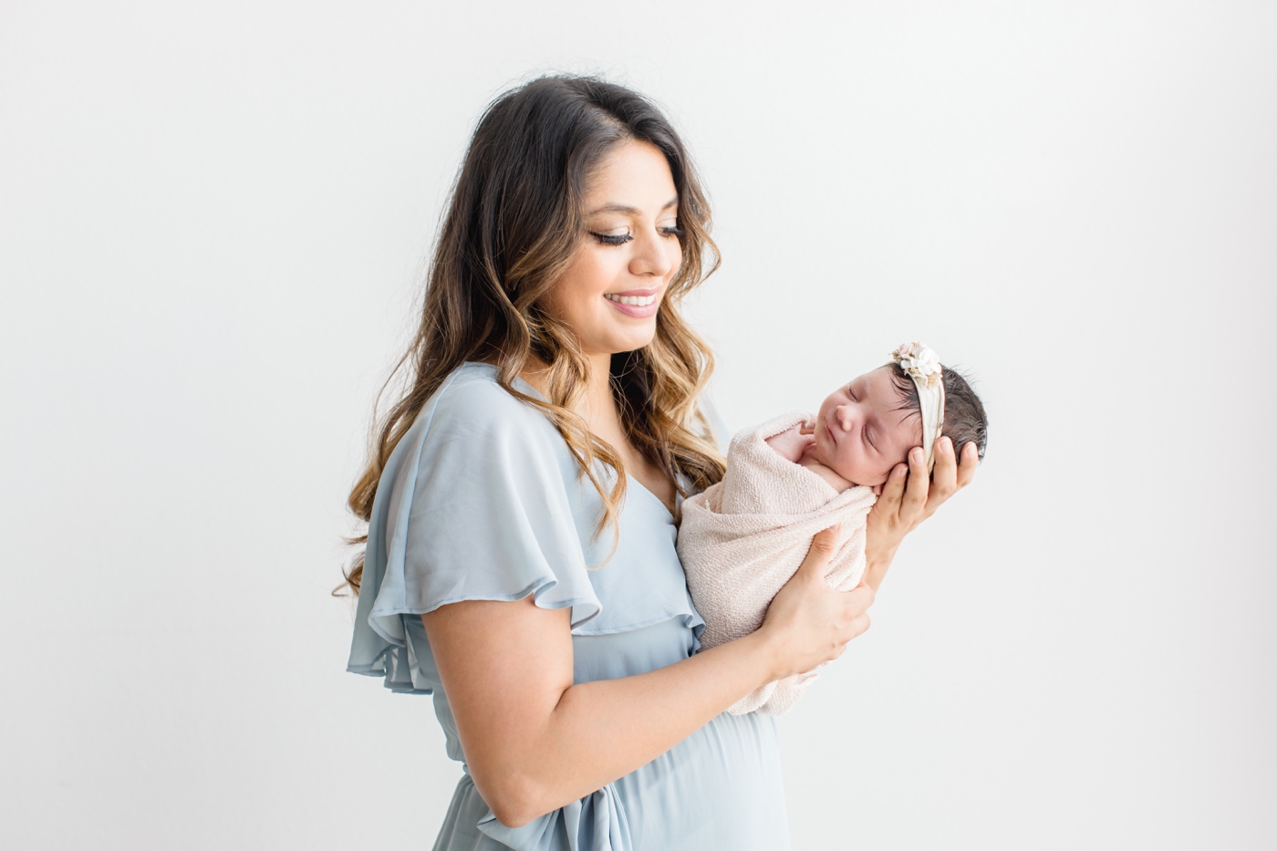 Mom holding baby during newborn session by Austin Newborn Photographer, Sana Ahmed Photography