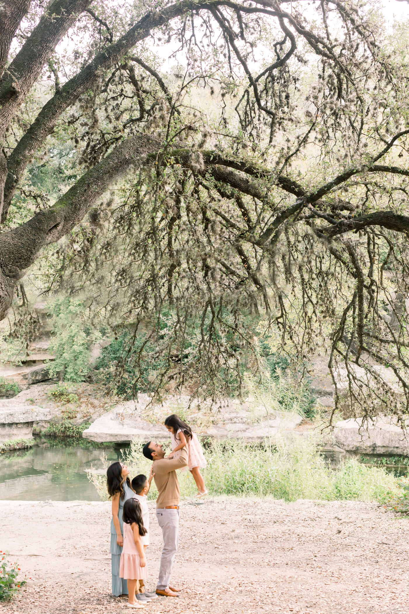 Family session under the oak trees in Austin, TX. Photo by Sana Ahmed Photography.