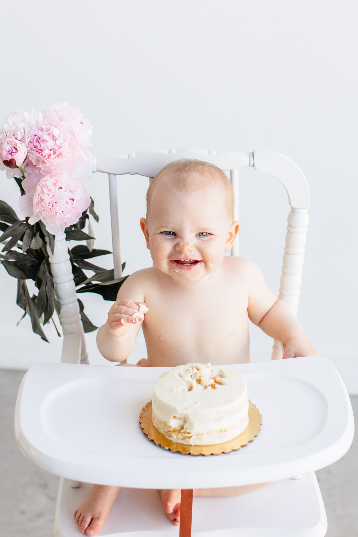 Big smile from toddler during her first birthday cake smash session in Austin. Photo by Sana Ahmed Photography.