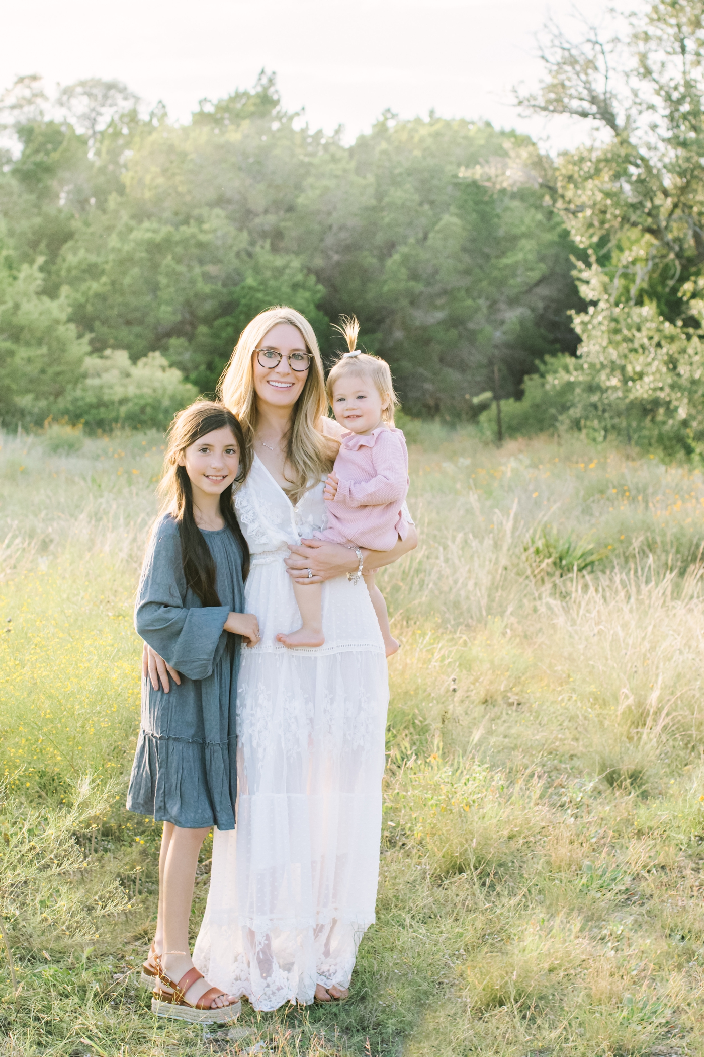 Mom with two daughters during family session. Photo by Austin Texas Family photographer, Sana Ahmed Photography
