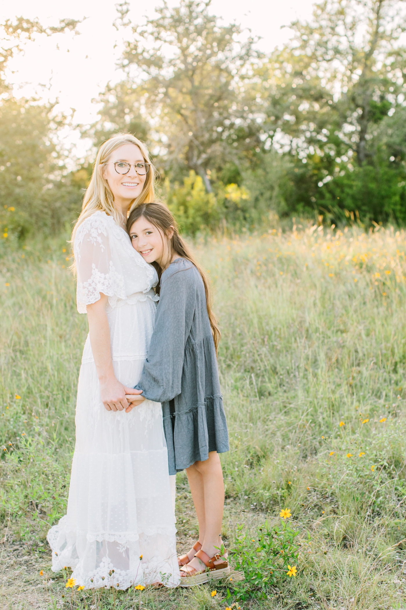 Mom with older daughter during sunny field session in Austin, TX. Photo by Sana Ahmed Photography