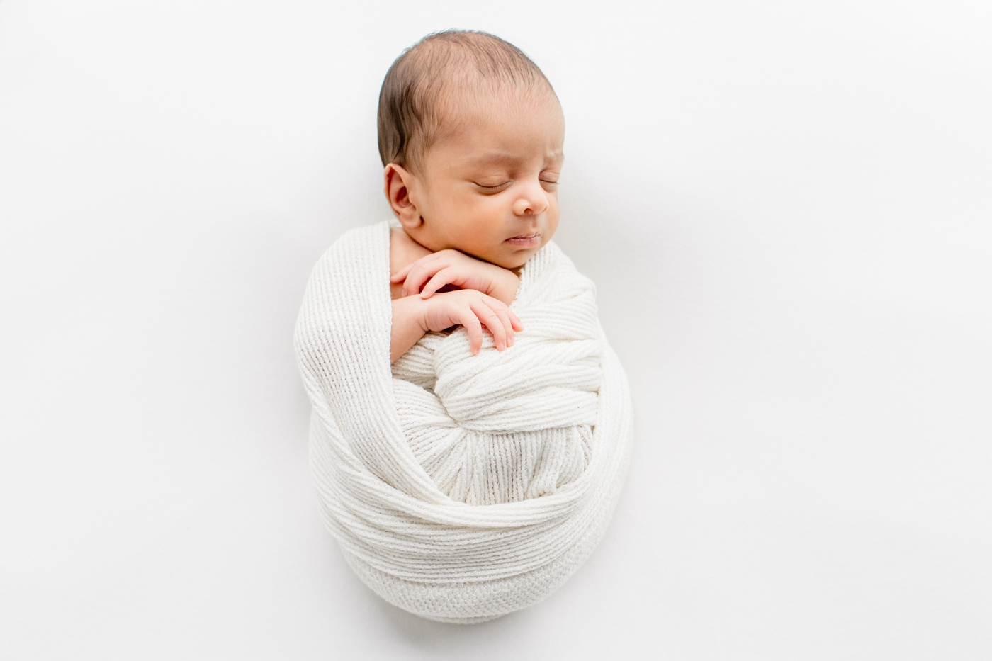 Baby boy swaddled with ribbed knit blanket by Austin TX newborn photographer, Sana Ahmed Photography.