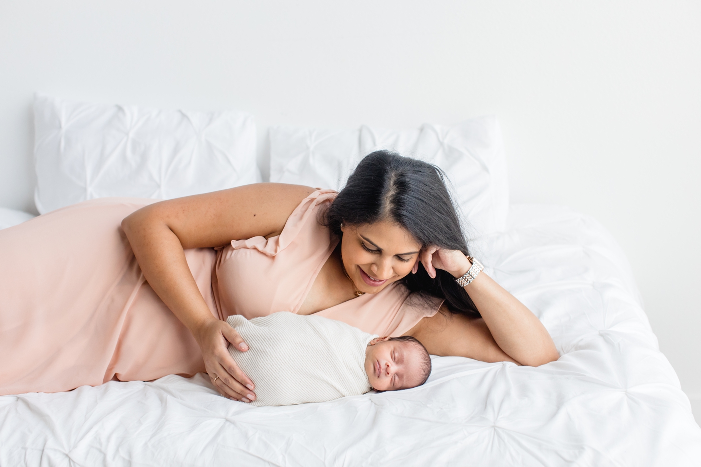 Mom laying next to baby during Austin TX newborn session. Photo by Sana Ahmed Photography.