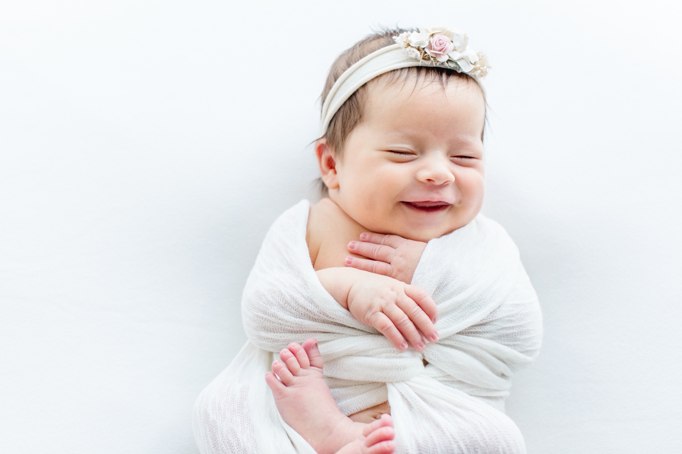 Newborn smiles during studio session with Sana Ahmed Photography.