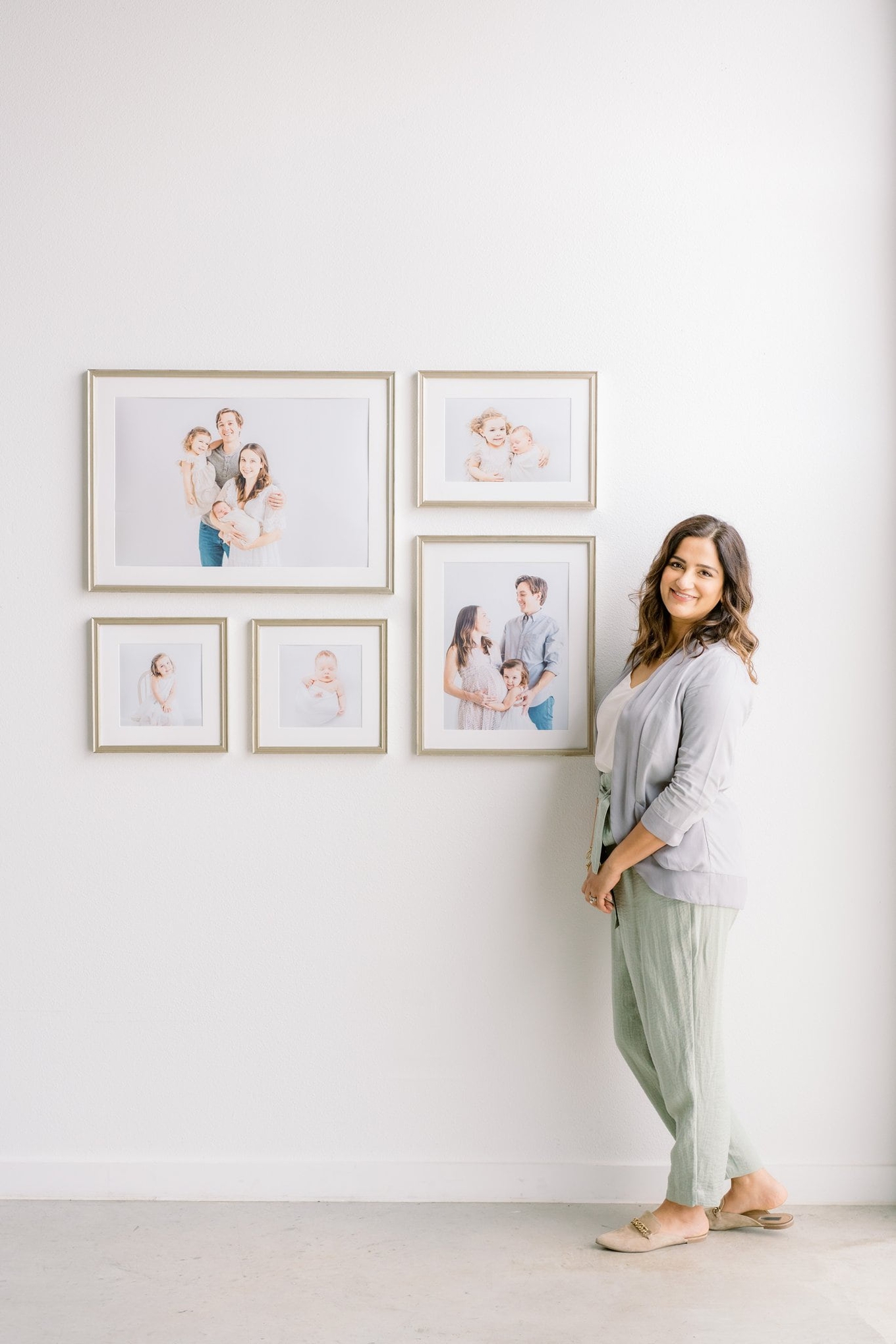 Beautiful custom-designed gallery wall with newborn and maternity images by Austin baby photographer, Sana Ahmed Photography.