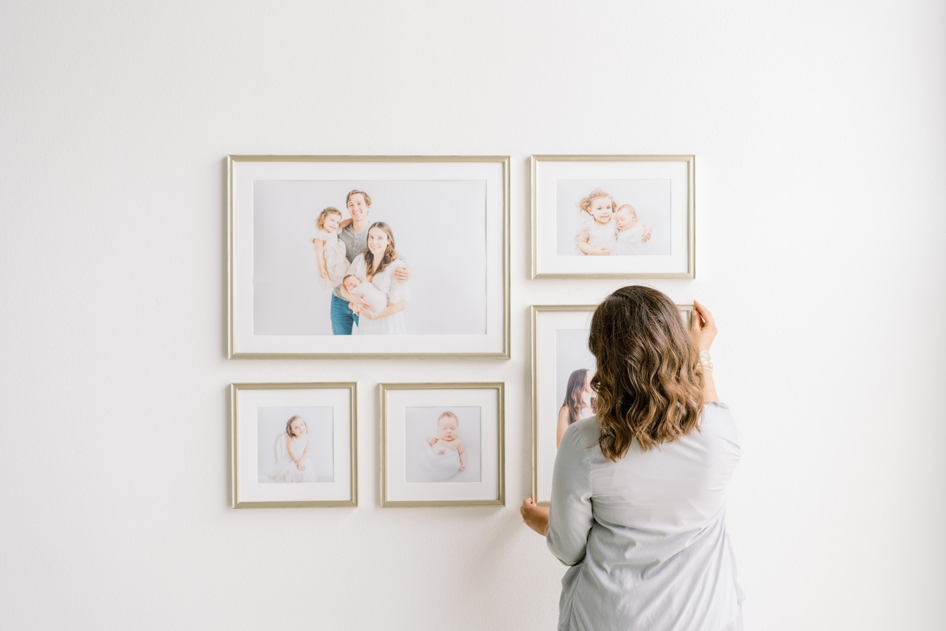 Custom-designed gallery wall with newborn and maternity images by Austin baby photographer, Sana Ahmed Photography.