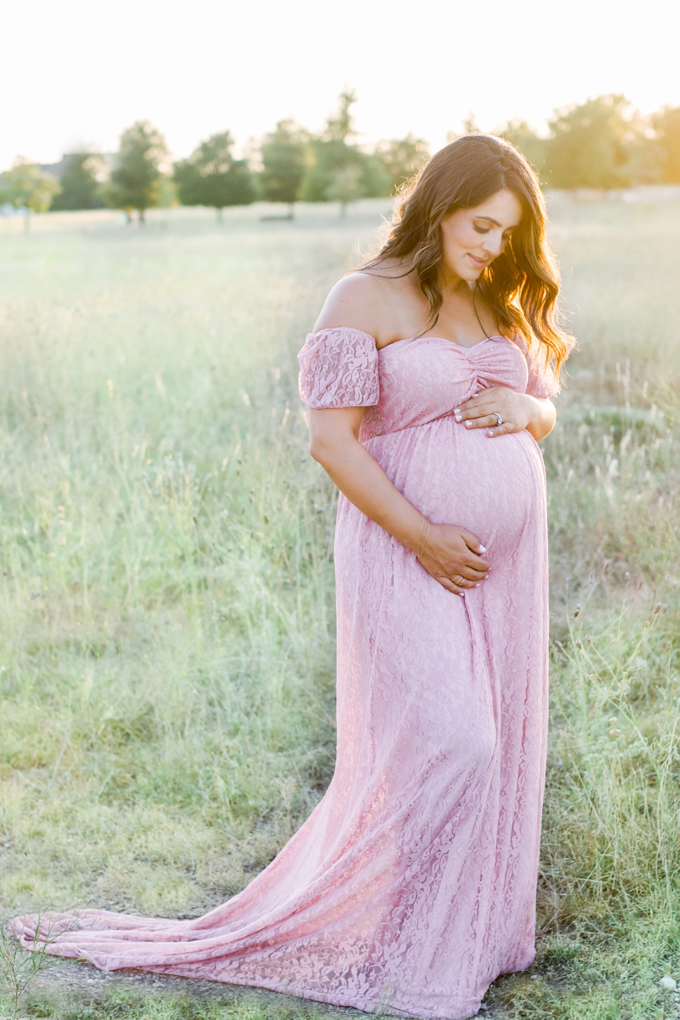 Sunset maternity session with Mom wearing pink lace maxi dress. Photo by Sana Ahmed Photography.