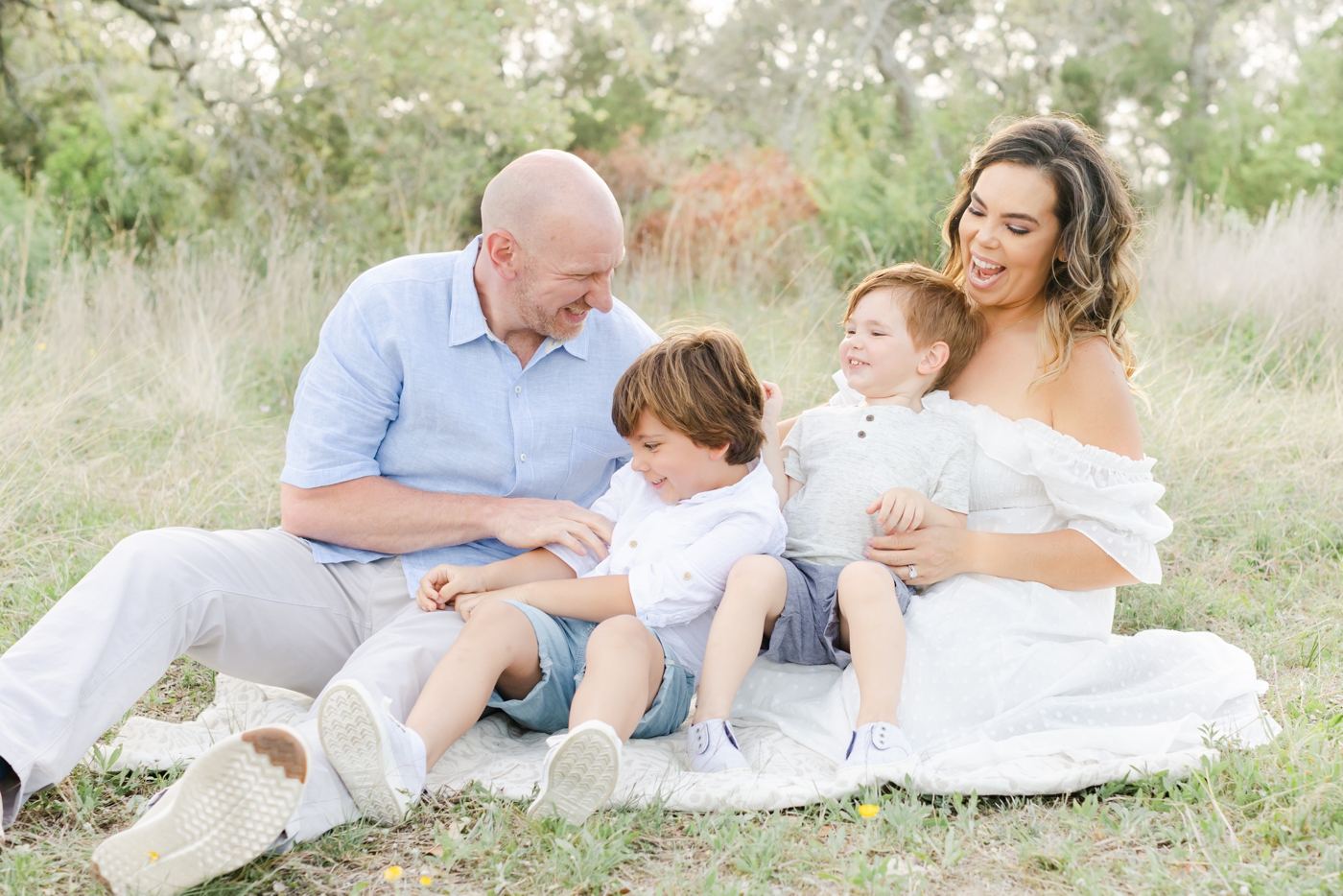 Candid portrait of family of four during field session near Cedar Park with Sana Ahmed Photography.