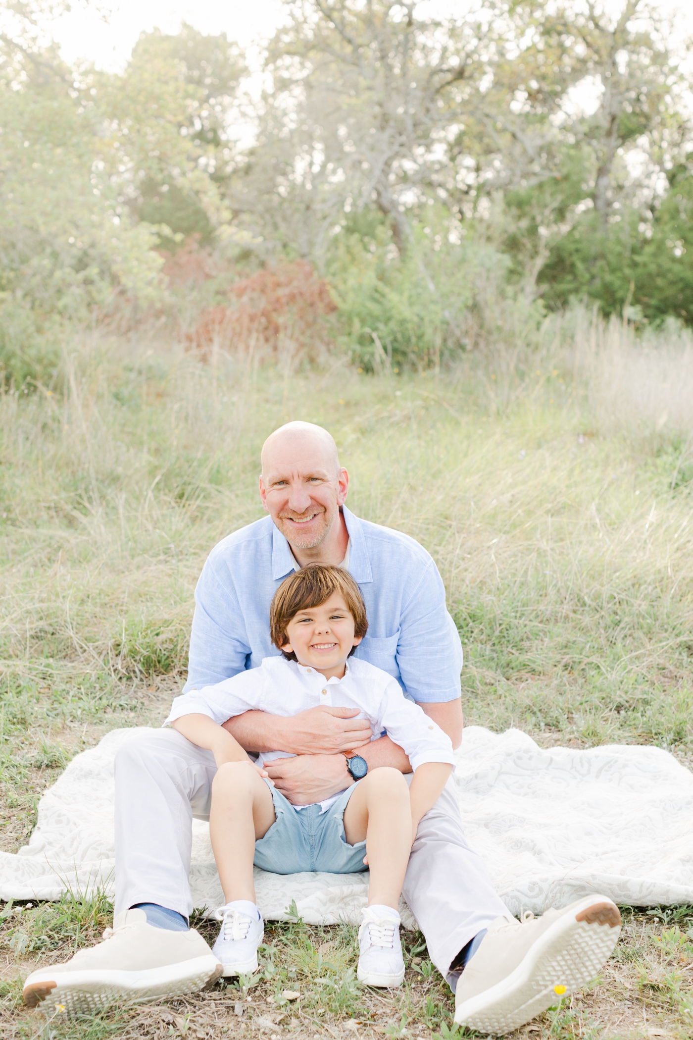 Dad sitting on the ground with oldest clients first! Photo by Cedar Park family photographer, Sana Ahmed Photography.