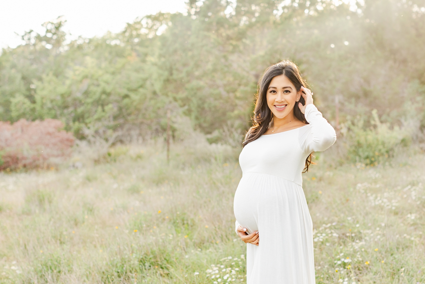 Beautiful pregnant Mom wearing white maxi dress during photoshoot with Round Rock photographer, Sana Ahmed Photography
