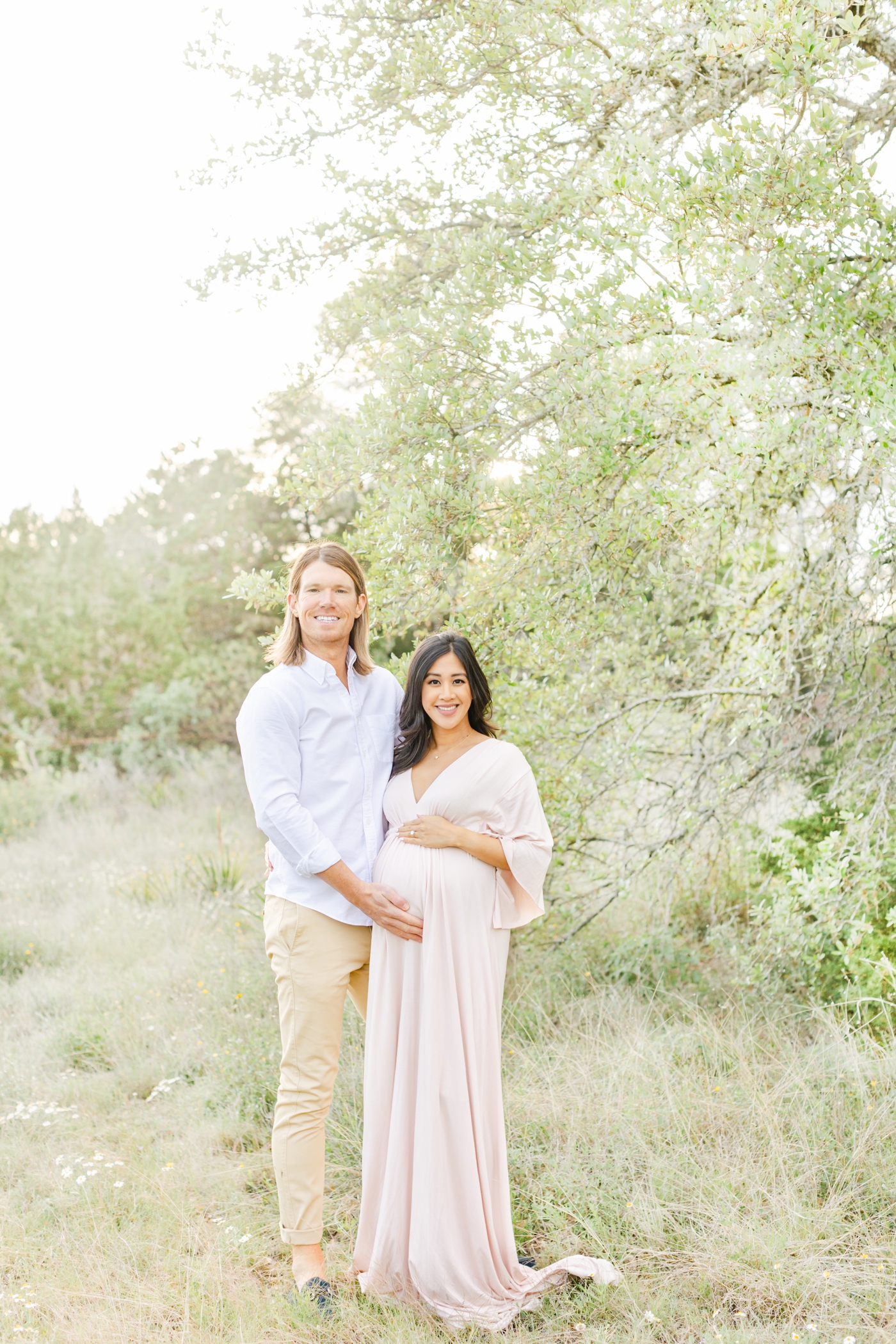 Classic smiling at the camera portrait during maternity photoshoot in Round Rock, TX by Sana Ahmed Photography.