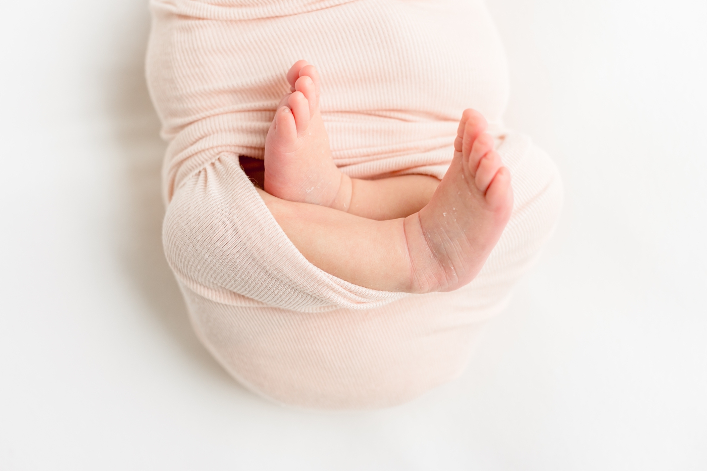 Closeup of baby feet during studio newborn session. Photo by Sana Ahmed Photography.