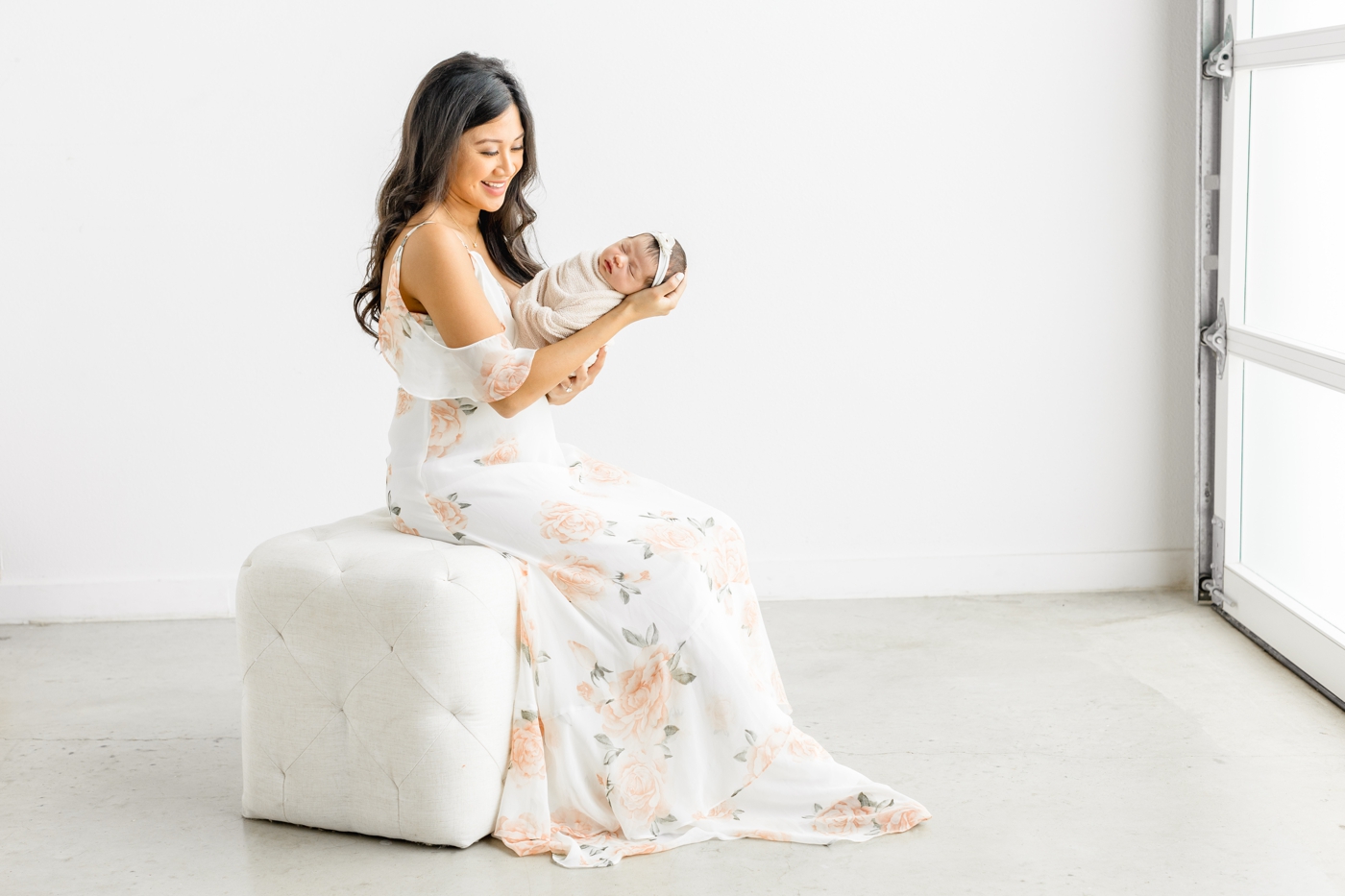Beautiful portrait of Mom holding newborn baby with Sana Ahmed Photography in her Austin studio.