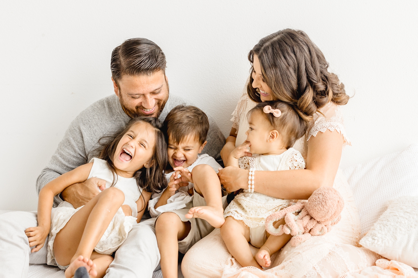 Candid moment of parents playing with kids during family session with Austin photographer, Sana Ahmed Photography.