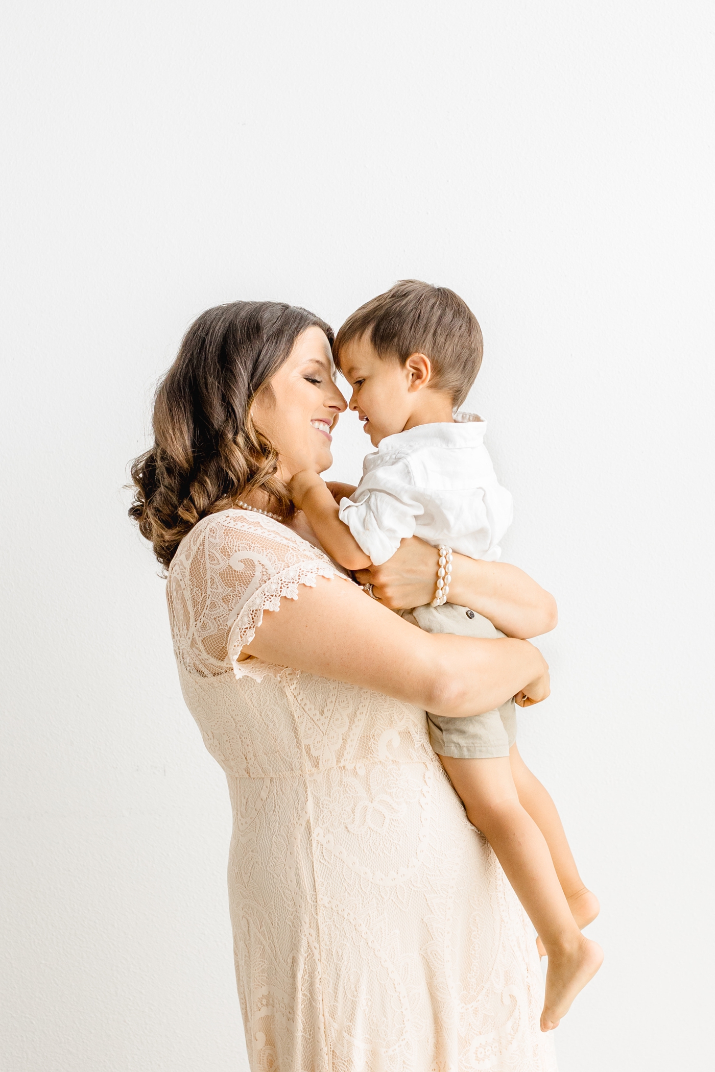 Mom hugging son during studio portrait session with full service photographer in Austin, Sana Ahmed Photography.
