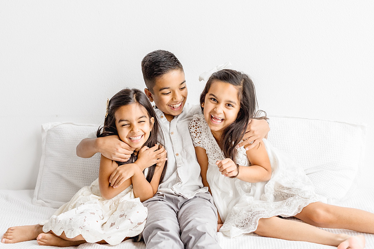 Candid photo of three kids during family session in Austin studio by Sana Ahmed Photography.