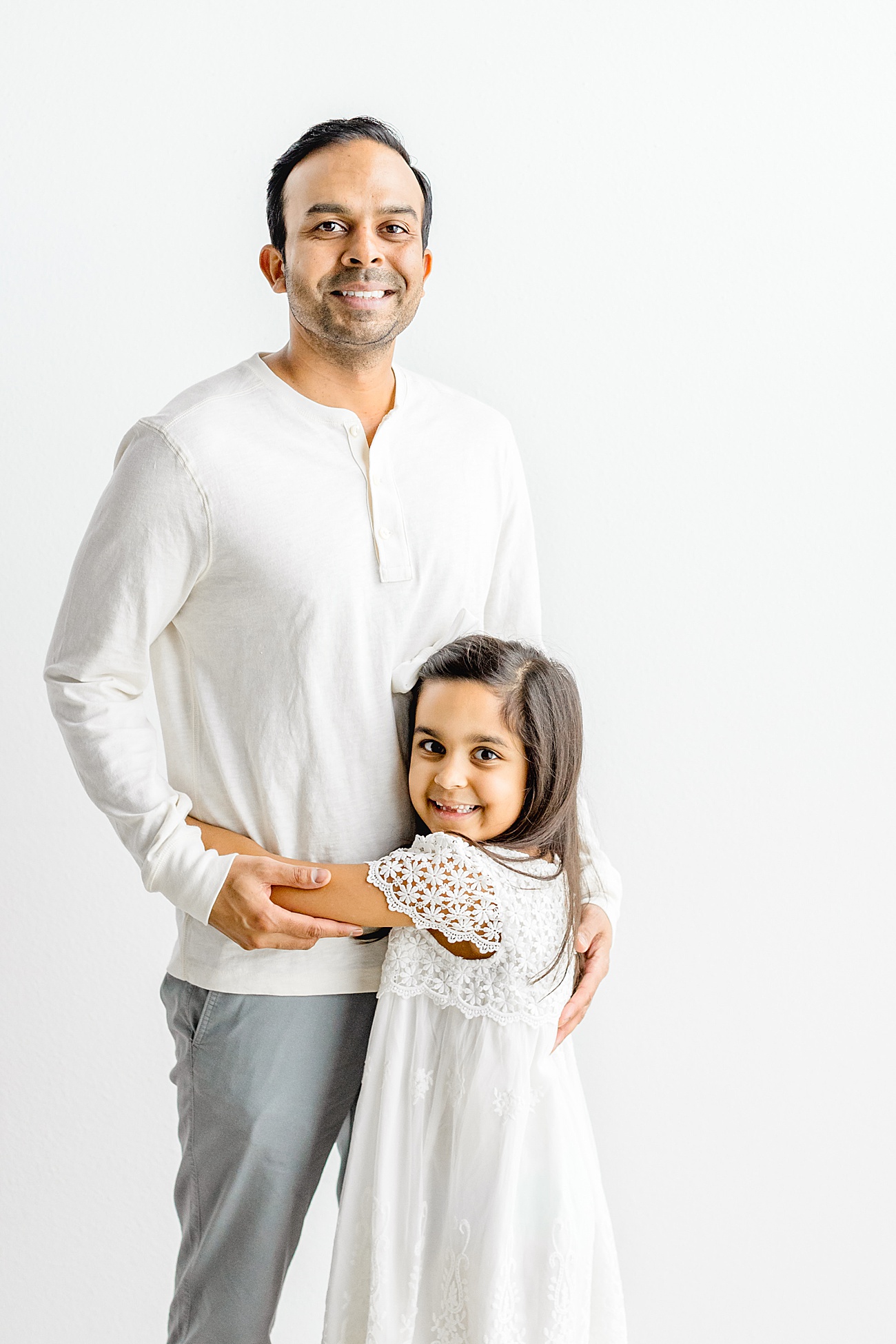 Dad smiling with daughter during session with Austin family photographer, Sana Ahmed Photography.