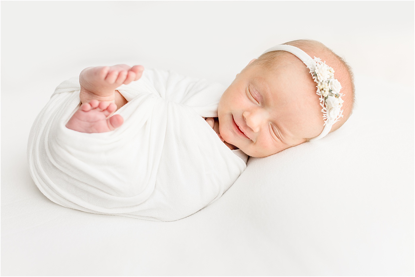 Smiling baby from newborn photography session in Austin studio. Photo by Sana Ahmed Photography.