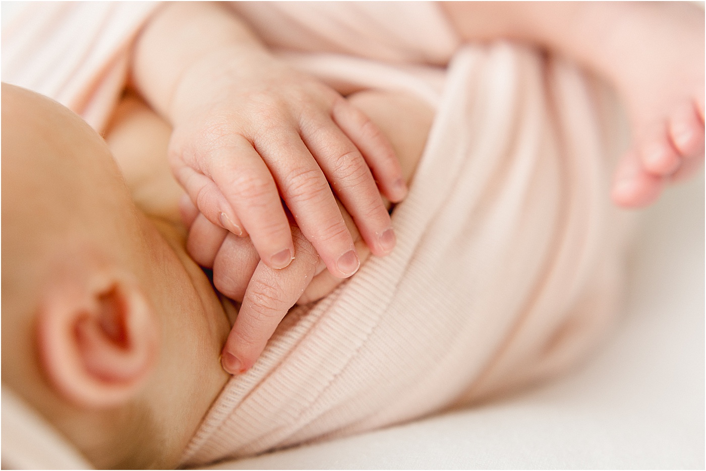 Closeup of baby's hands during studio newborn session with Sana Ahmed Photography.