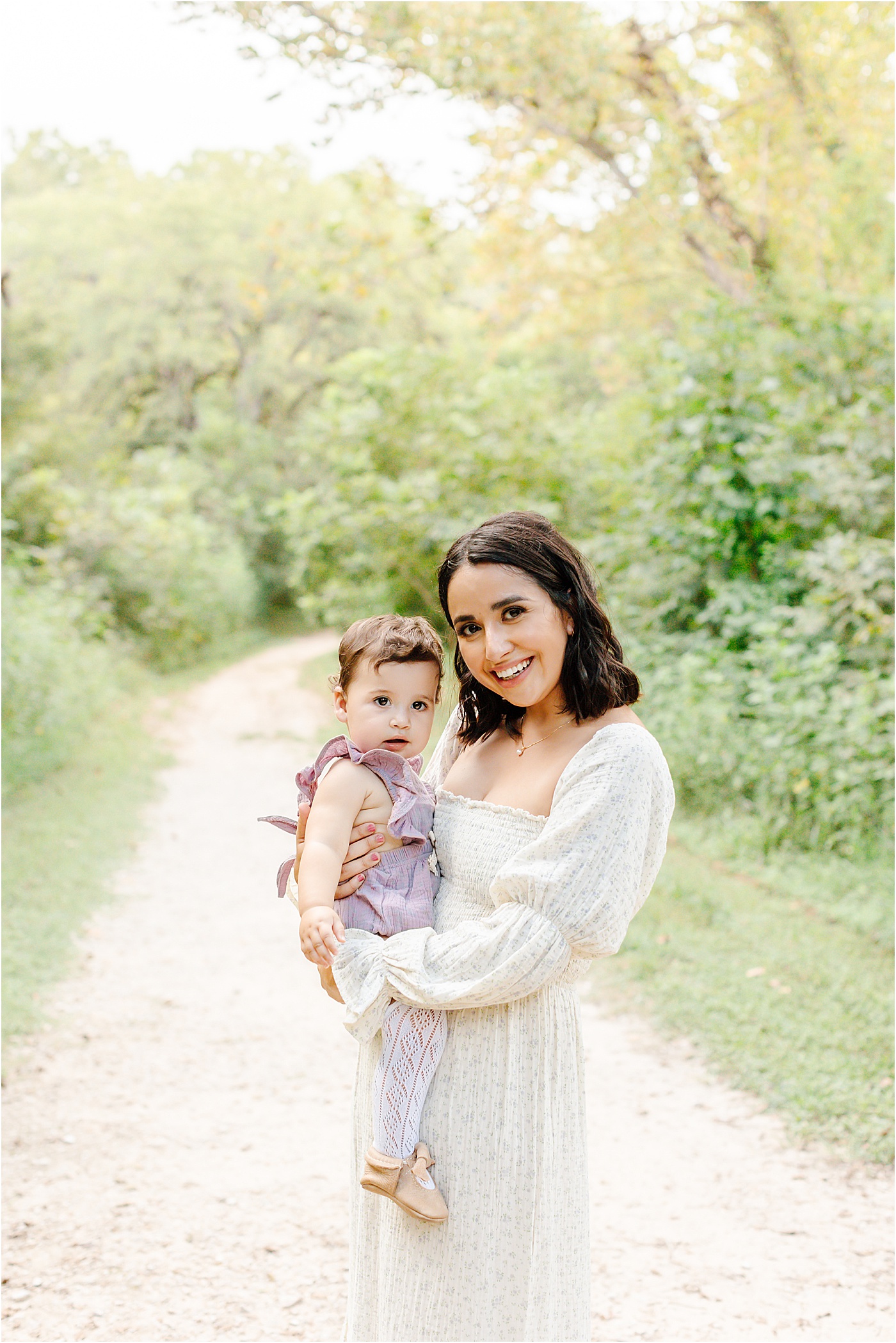 Mom and daughter smiling at the camera during field session near Austin, TX. 