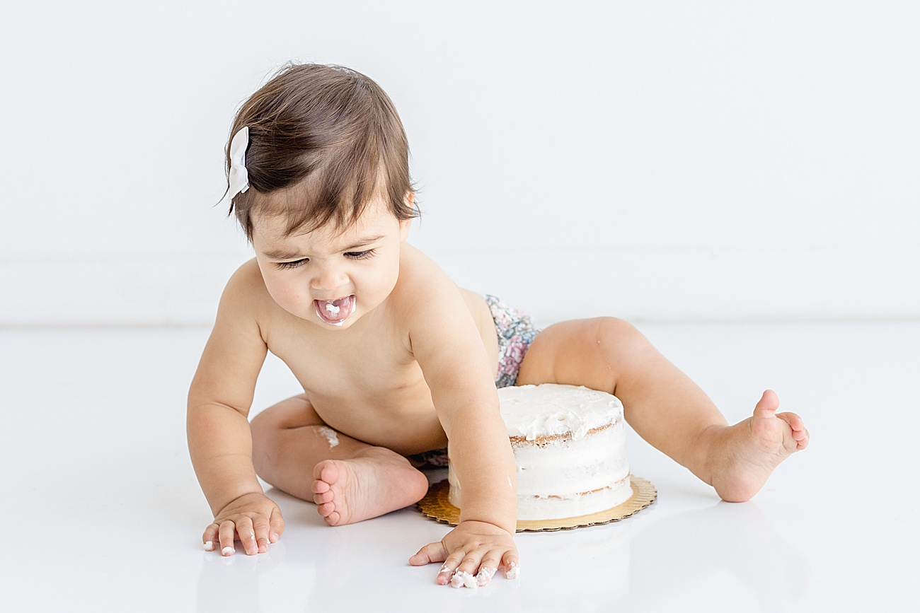 Baby unhappy with frosting taste at cake smash session. Photo by Sana Ahmed Photography
