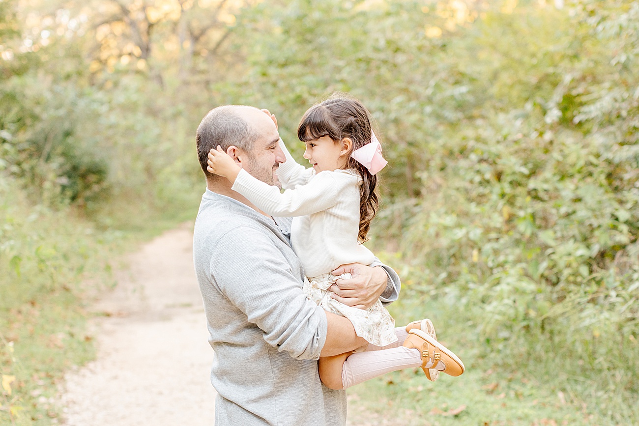 Sweet Dad and daughter moment in beautiful sunlit field. Photo by Sana Ahmed Photography