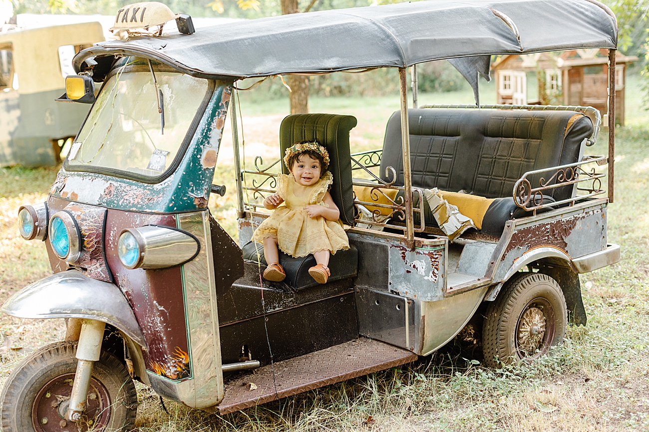 Little girl seeing in car during family session in unique location outside of Austin, TX. Photo by Sana Ahmed Photography