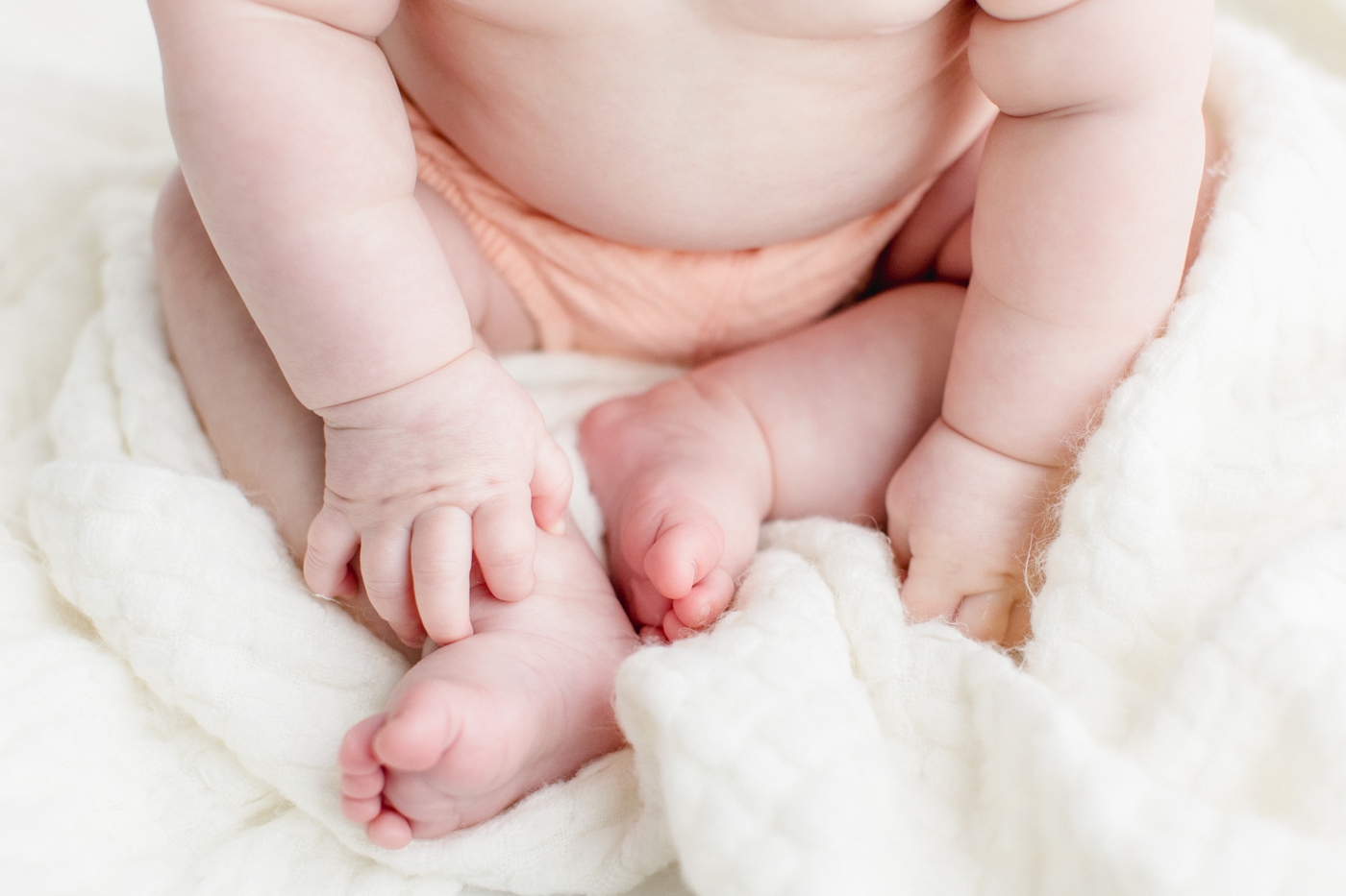Detail photo of baby girl's hands and feet. Photo by Sana Ahmed Photography.