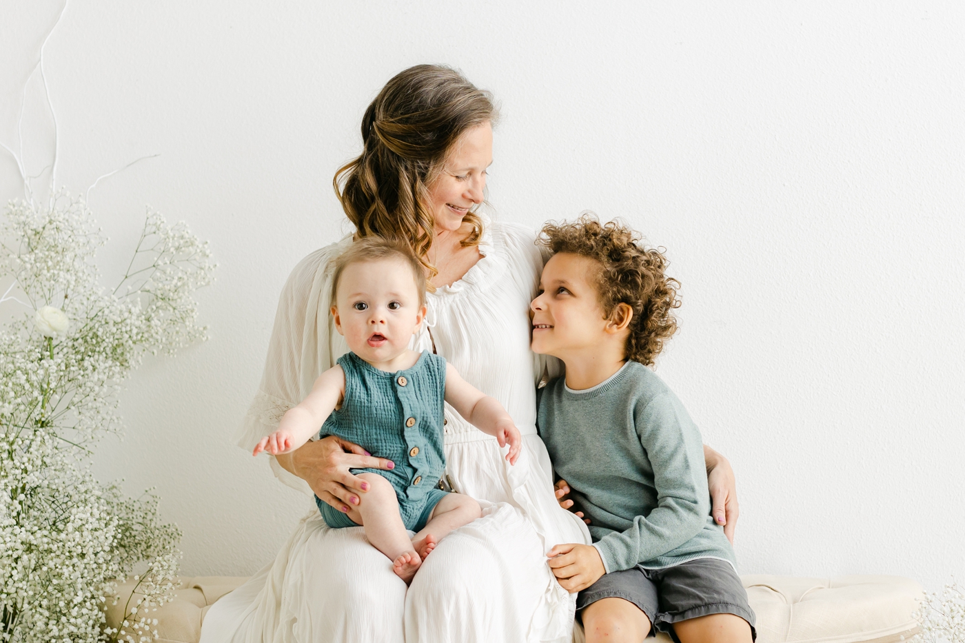 Candid portrait of Mom with two boys during studio mini sessions with Sana Ahmed Photography.