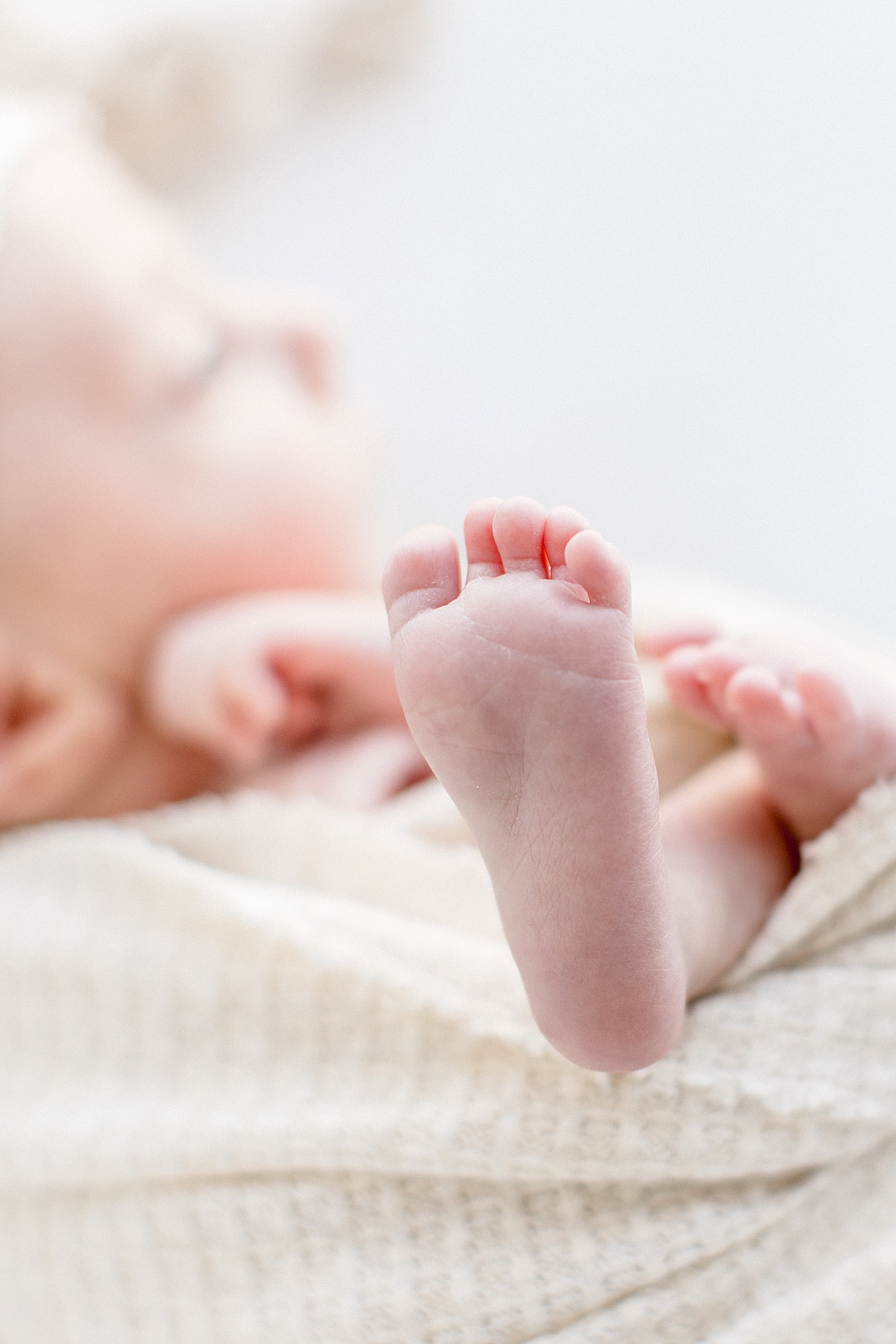 Closeup of baby's feet during newborn photoshoot in Austin with Sana Ahmed Photography.