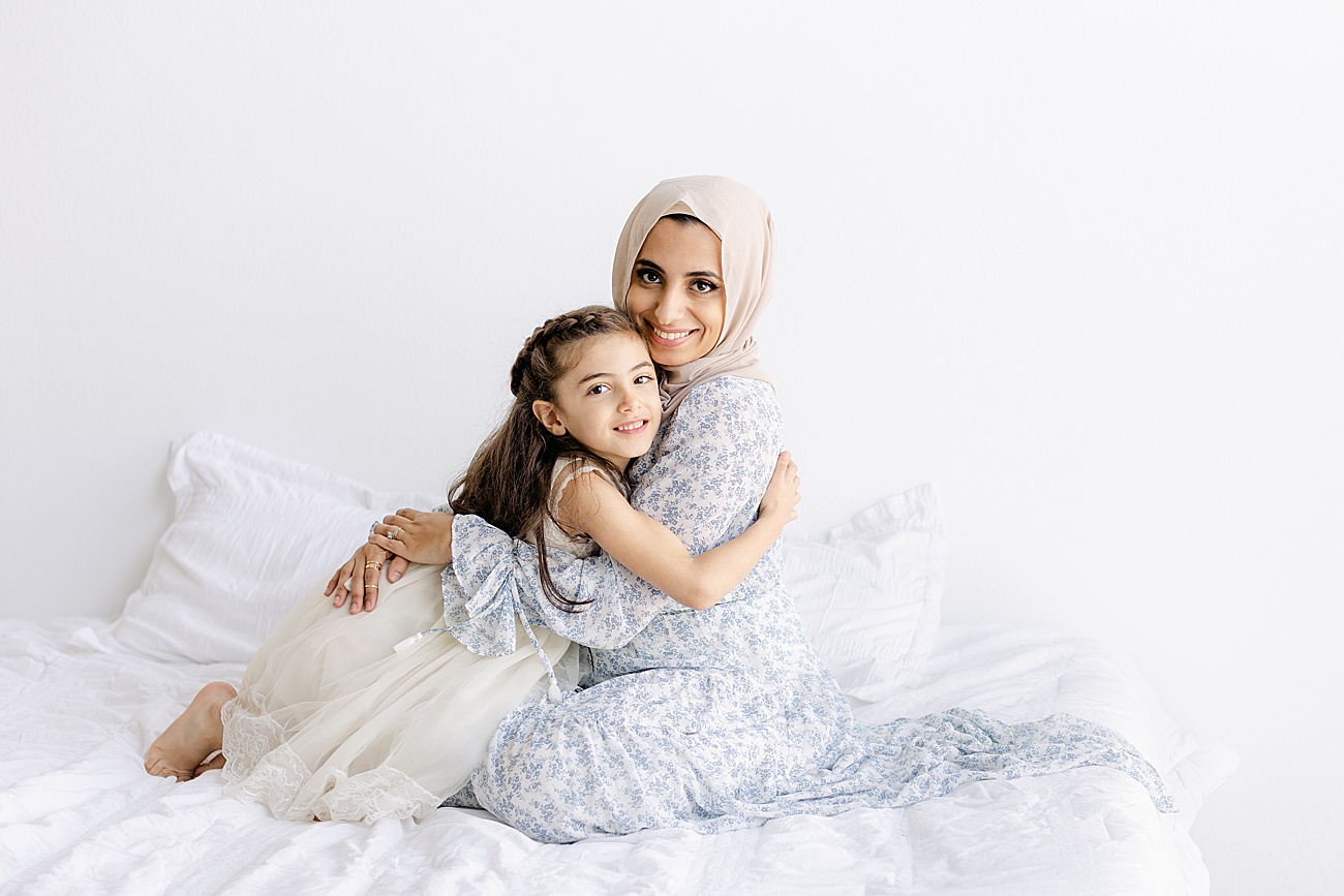 Mom and daughter hugging during family session in Sana Ahmed Photography's Austin studio.