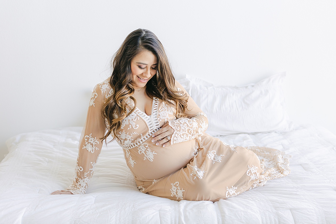 Expecting first time Mom in beautiful lace dress during maternity session. Photo by Sana Ahmed Photography.