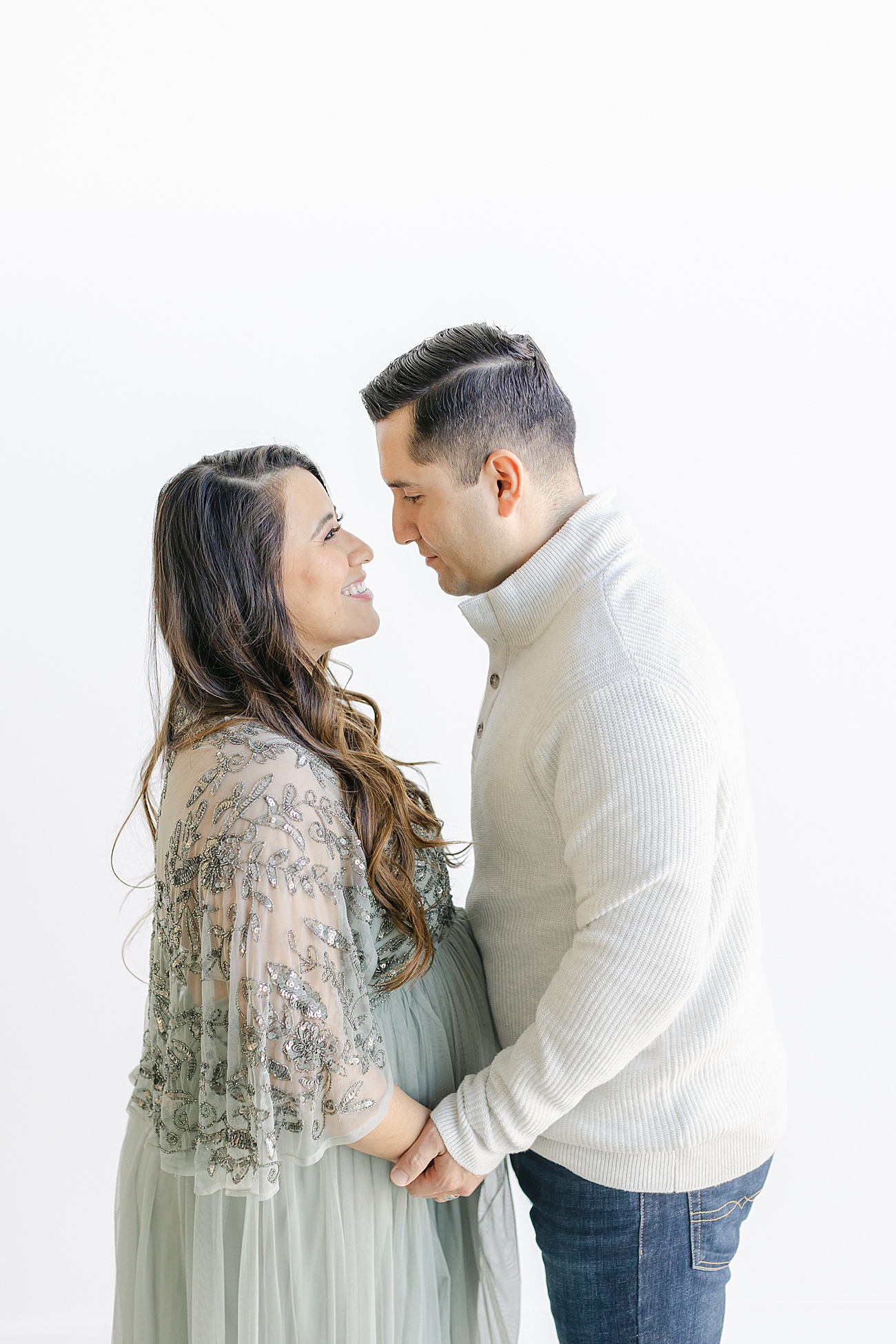 Sweet image of Mom and Dad embracing baby bump during maternity photoshoot in Austin, TX. Photo by Sana Ahmed Photography.