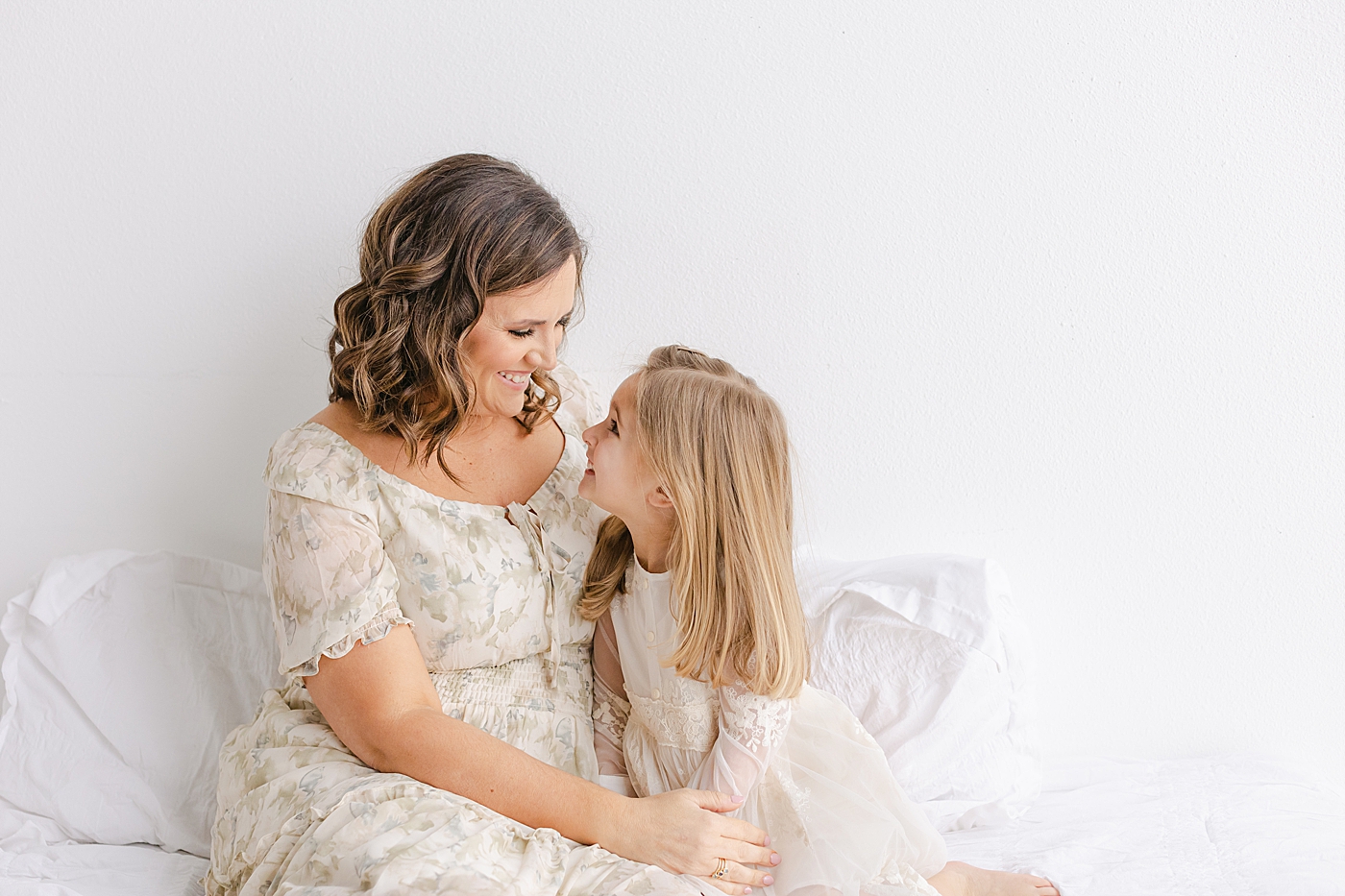 Little girl snuggling with her mom during their playful family studio session in Austin | Photo by Sana Ahmed Photography