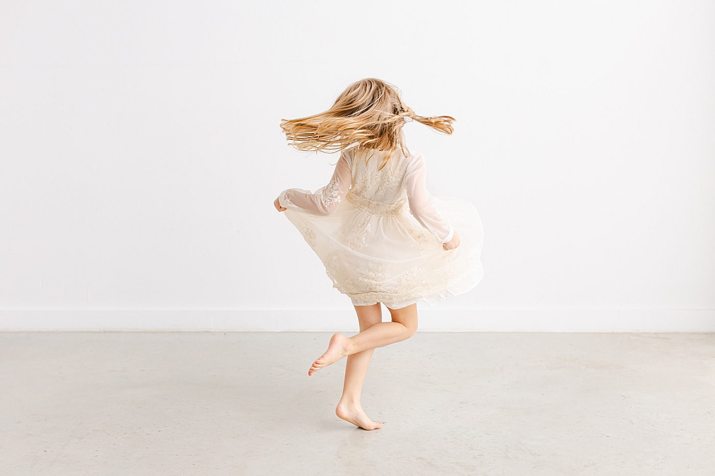 Little girl twirling during playful family studio session in Austin | Photo by Sana Ahmed Photography