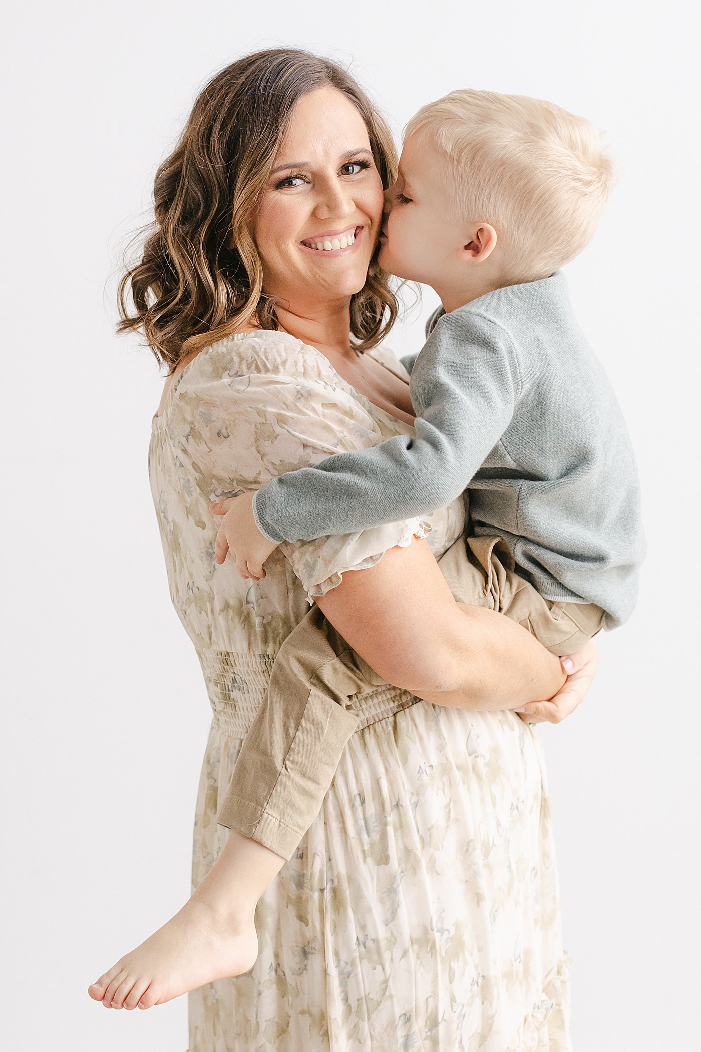 Mom snuggling with her little boy during their playful family studio session in Austin | Photo by Sana Ahmed Photography