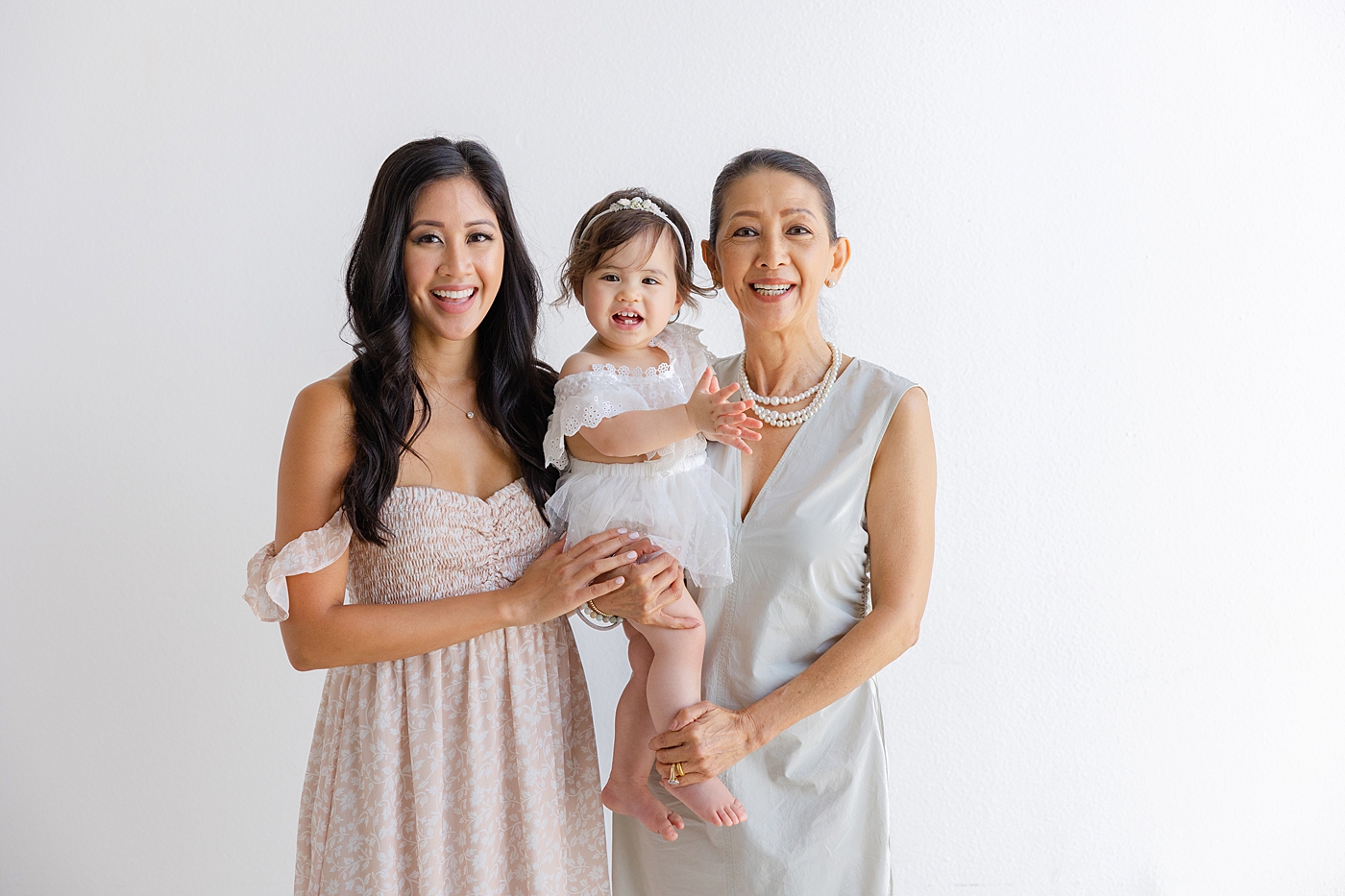 Baby girl with her mom and grandma during her one year studio milestone session| Image by Sana Ahmed Photography