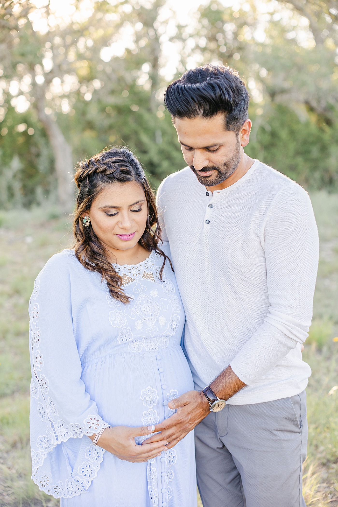 Mom and dad to be cradling mom's belly | Photo by Sana Ahmed Photography