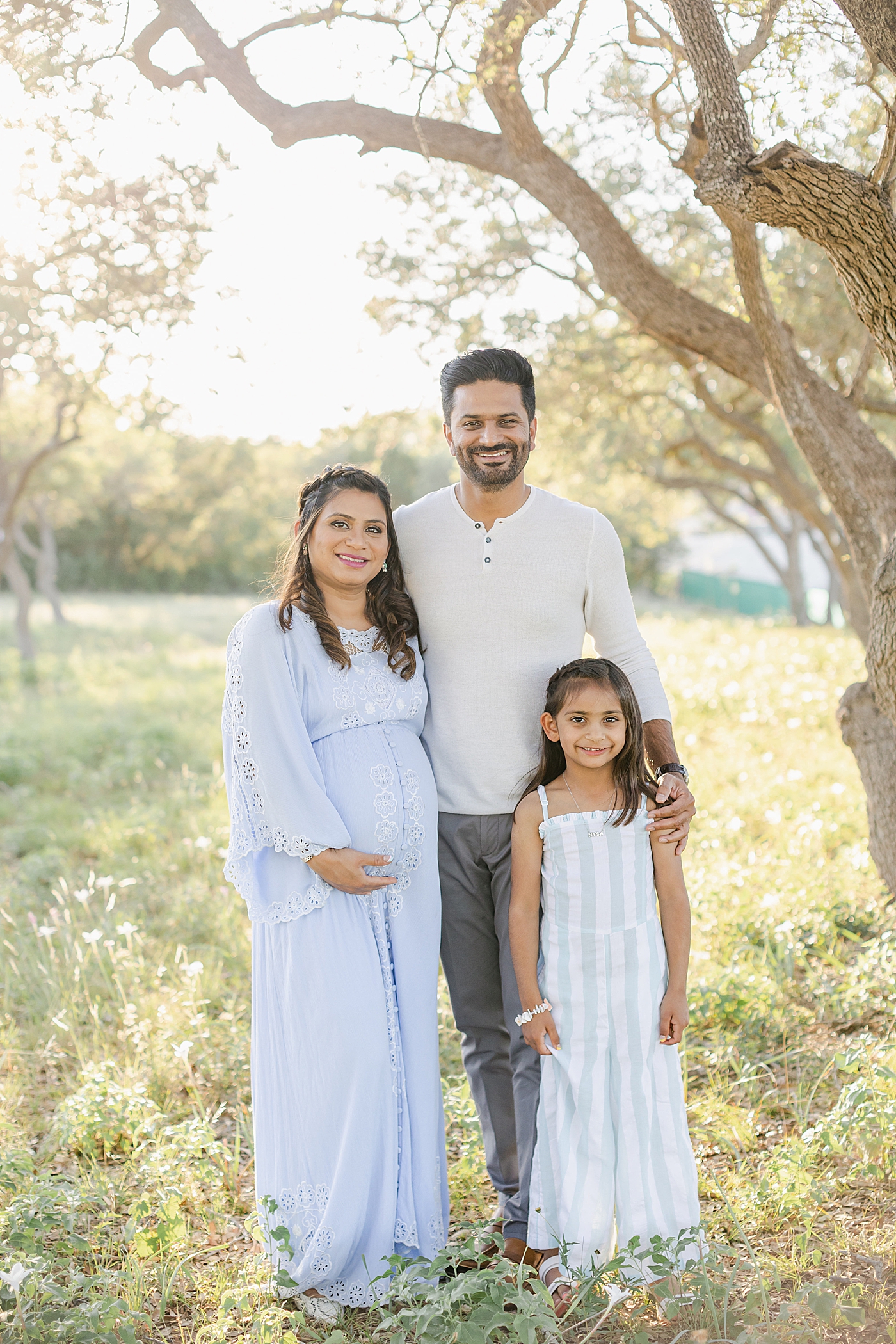 Family of three during their Outdoor Maternity Session in Austin | Photo by Sana Ahmed Photography