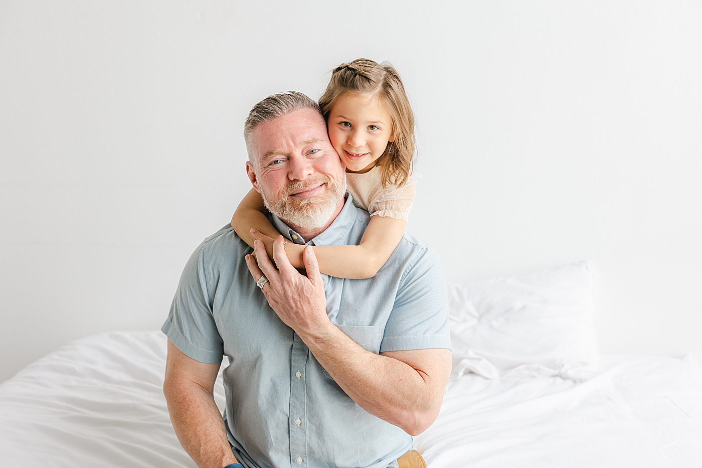 Little girl snuggling her dad during their Studio Family Session in Austin | Photo by Sana Ahmed Photography