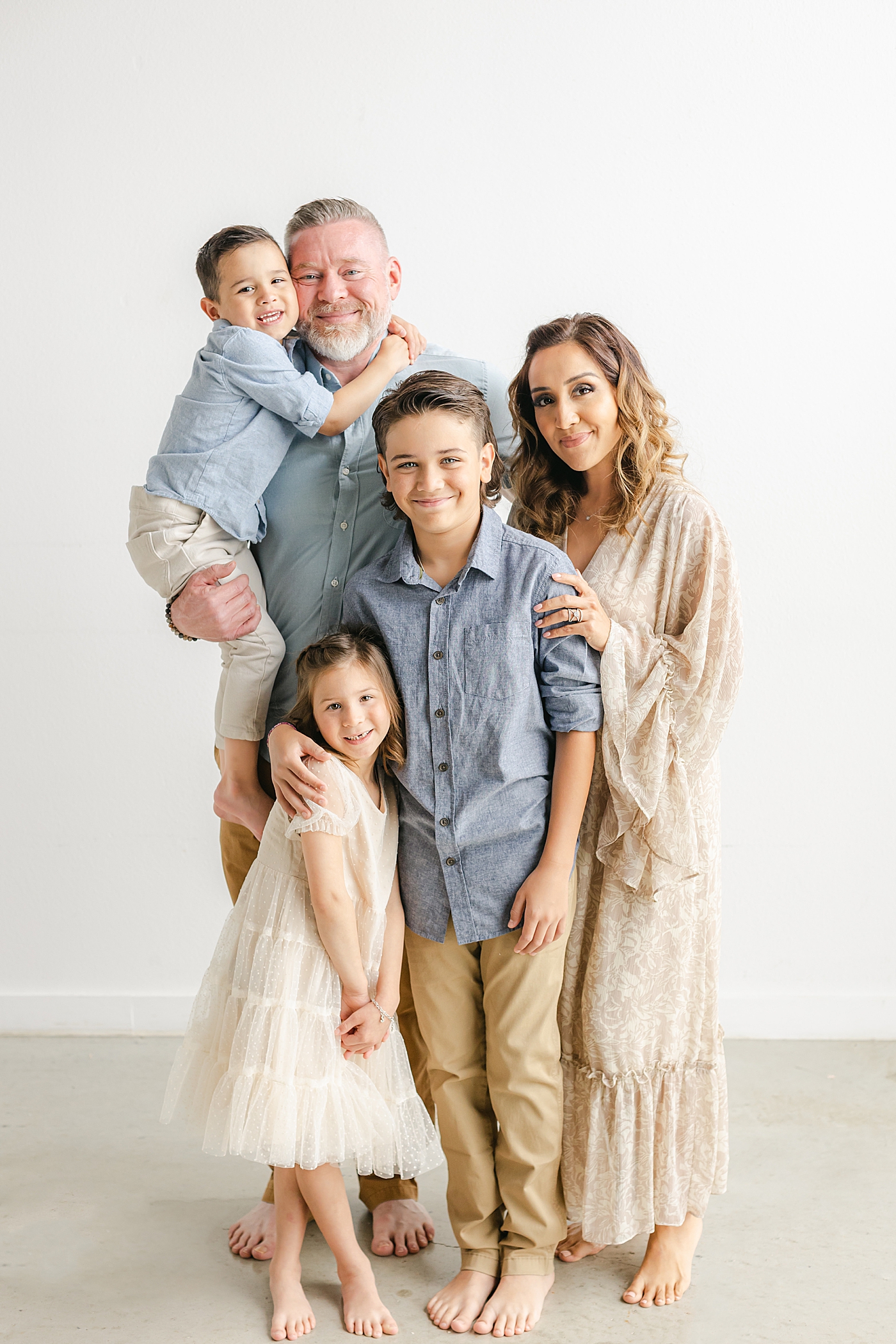 Family of five snuggling during their Studio Family Session in Austin | Photo by Sana Ahmed Photography