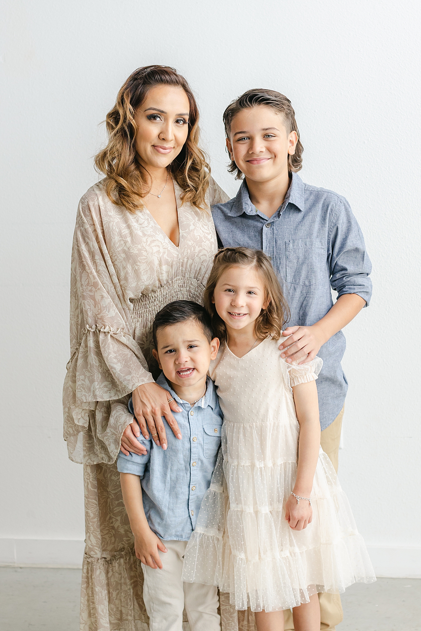 Mom snuggling with her kids during their Studio Family Session in Austin | Photo by Sana Ahmed Photography