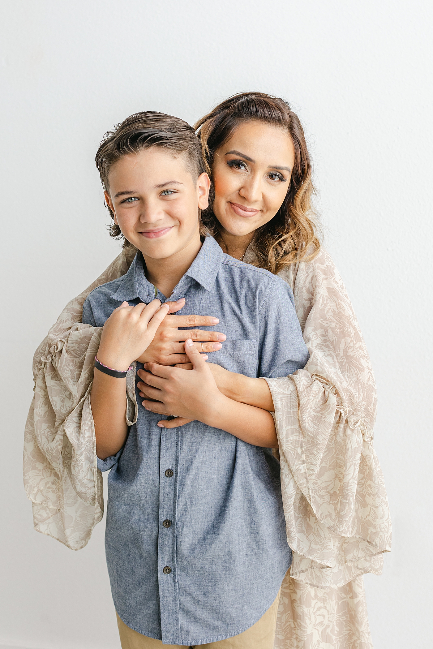 Mom hugging her oldest son during their Studio Family Session in Austin | Photo by Sana Ahmed Photography