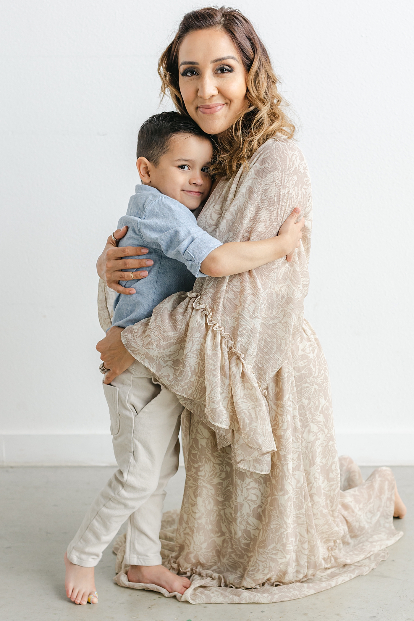 Mom snuggling with her youngest son during their Studio Family Session in Austin | Photo by Sana Ahmed Photography