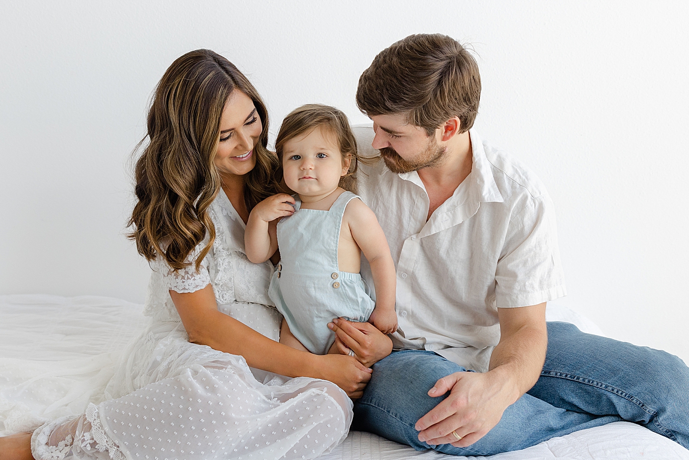 Mom and dad interacting with their toddler during their Studio Family Session | Photo by Sana Ahmed Photography