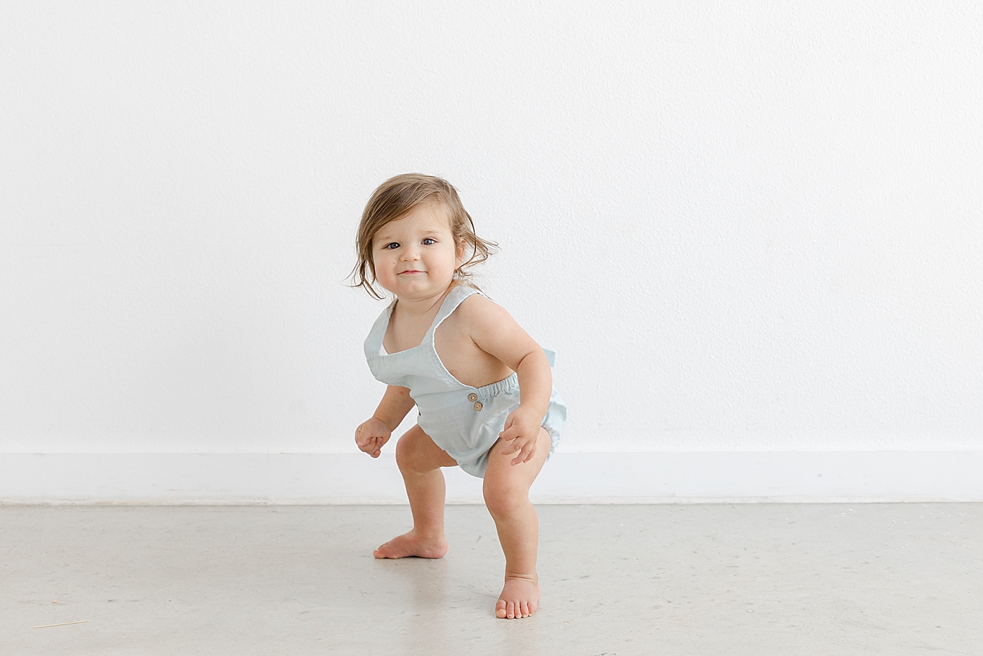 Baby girl practicing her standing | Photo by Sana Ahmed Photography