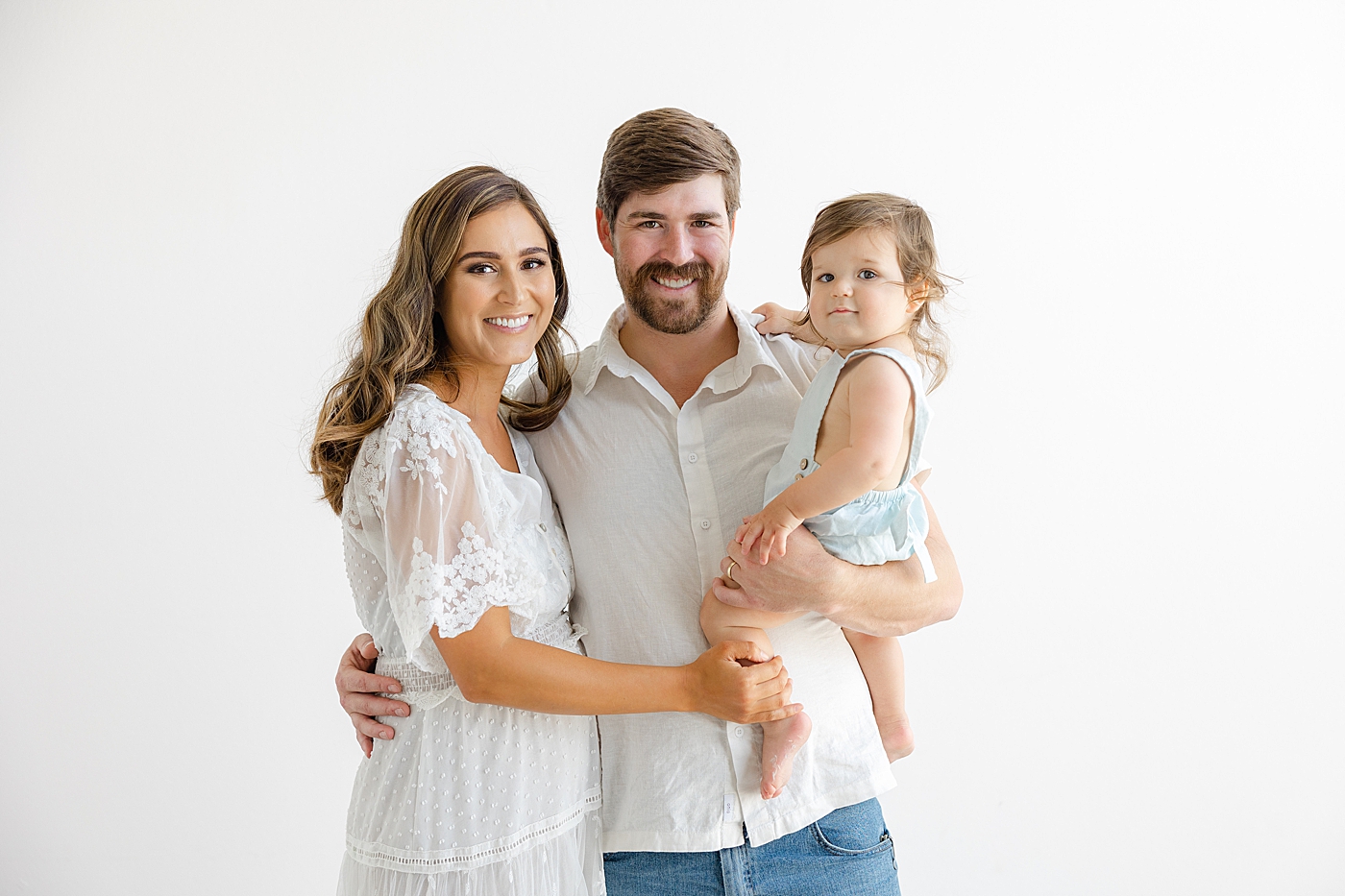 Mom and dad with their toddler during their Studio Family Session | Photo by Sana Ahmed Photography