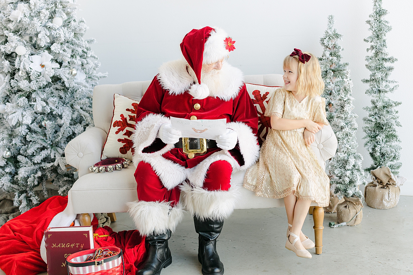 Little girl in gold dress sitting with Santa during Santa Sessions in Austin | Images by Sana Ahmed Photography