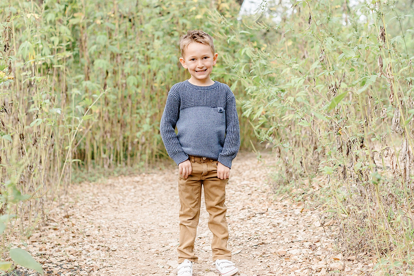 Smiling little boy in a blue sweater | Image by Sana Ahmed Photography